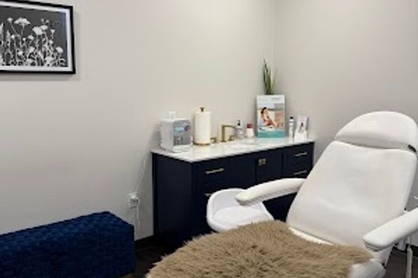 Clean, professional medical spa treatment room with neutral tones at Luxe Level Aesthetics in Darien
